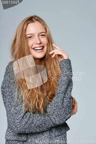 Image of Woman muffling in warm knitted cardigan