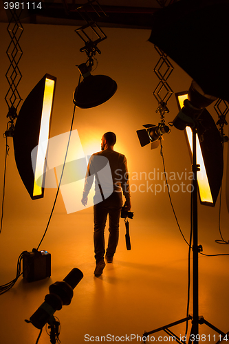 Image of Silhouette of photographer and studio shot as workplace