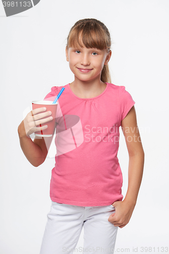 Image of Little child girl holding a drink in disposable paper cup