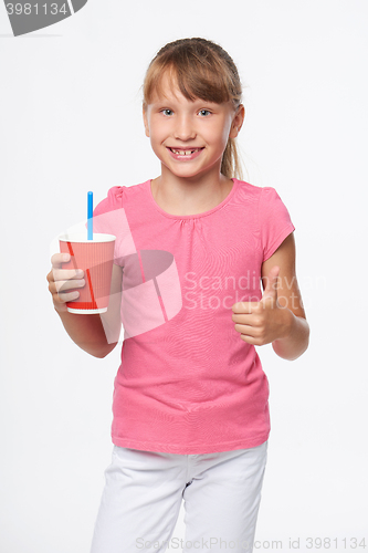 Image of Little child girl holding a drink in disposable paper cup