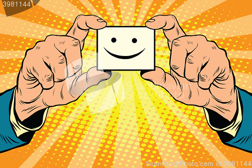 Image of joy Smiley face in hands