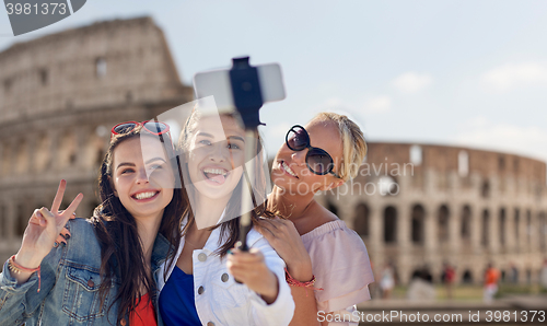 Image of group of smiling women taking selfie in rome