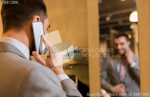 Image of close up of man calling on cellphone at store