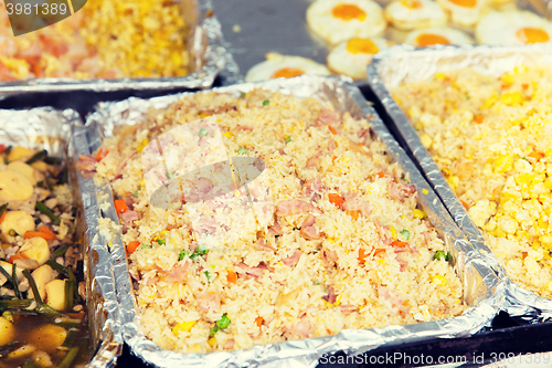 Image of wok or pilaf dish at street market