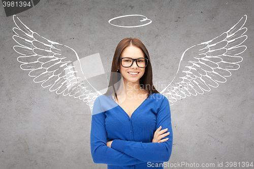 Image of happy businesswoman with angel wings and nimbus