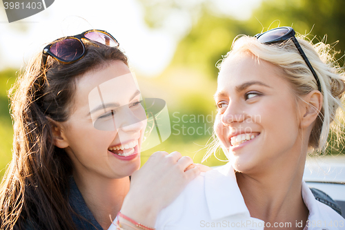 Image of happy women or teenage girls laughing outdoors