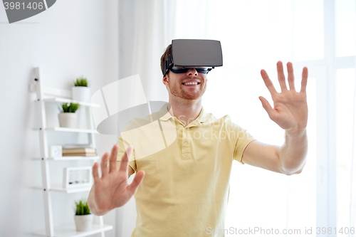 Image of young man in virtual reality headset or 3d glasses