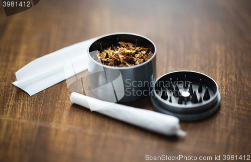 Image of close up of marijuana joint and herb grinder