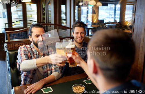 Image of happy male friends drinking beer at bar or pub