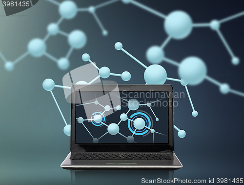 Image of laptop computer with molecules structure on screen