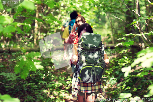 Image of close up of friends with backpacks hiking