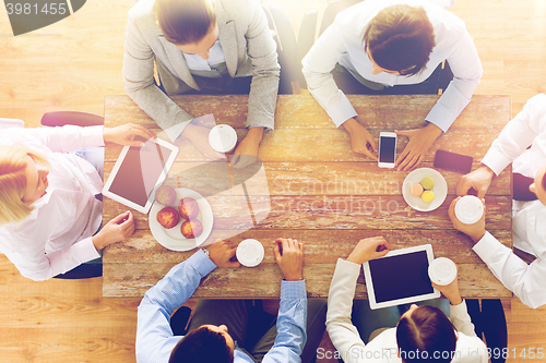 Image of close up of business team drinking coffee on lunch