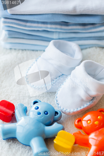 Image of close up of baby rattle and bootees for newborn