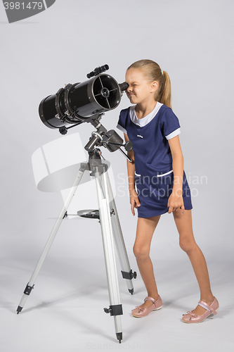 Image of Young funny astronomer looks through the eyepiece of the telescope