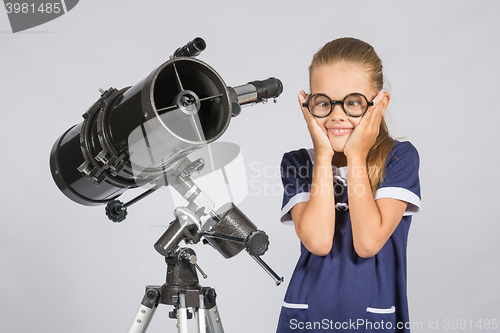 Image of The young astronomer funny glasses made a face