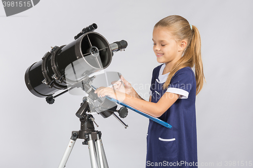 Image of Astronomer happily looks at records with observations