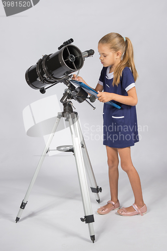 Image of The astronomer carefully recorded observations on a sheet of paper