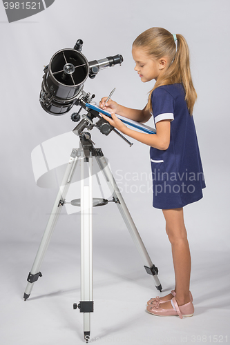 Image of Young Astronomer writes the results of observations in the Documents folder