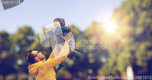 Image of father with son playing and having fun outdoors