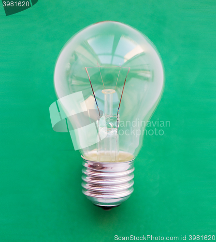 Image of close up of bulb or incandescent lamp on green