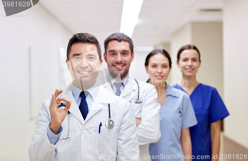 Image of group of happy medics or doctors at hospital