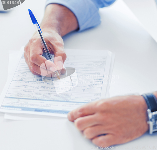 Image of man filling tax form