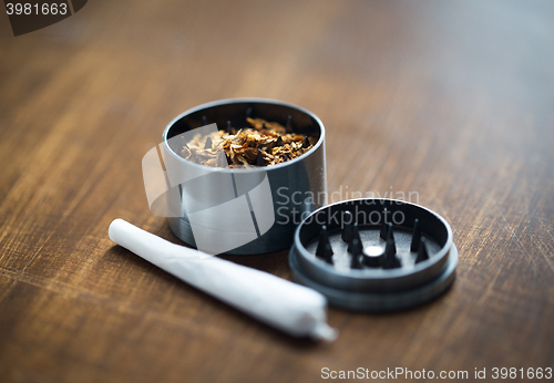 Image of close up of marijuana joint and herb grinder