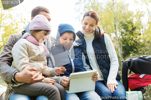 Image of happy family with tablet pc and backpacks at camp