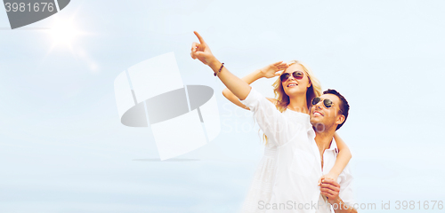 Image of couple in shades at sea side