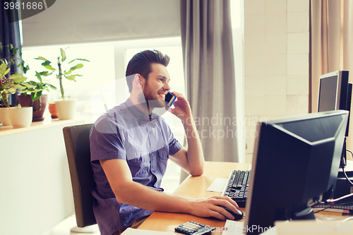 Image of happy creative male worker calling on smarphone