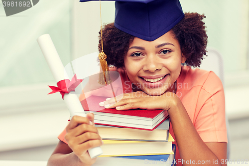 Image of happy african bachelor girl with books and diploma