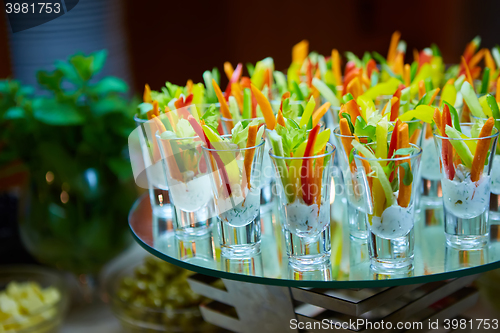 Image of Colorful slices of raw vegetables in glasses