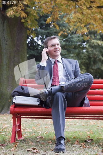 Image of Businessman talking on cell phone