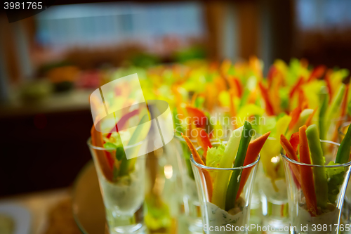 Image of Colorful slices of raw vegetables in glasses