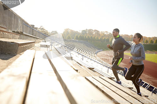 Image of couple running upstairs on stadium