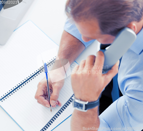 Image of handsome businessman talking on the phone