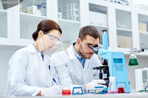 Image of young scientists making test or research in lab