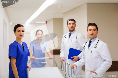 Image of group of doctors with gurney at hospital