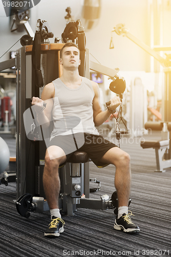 Image of man exercising on gym machine