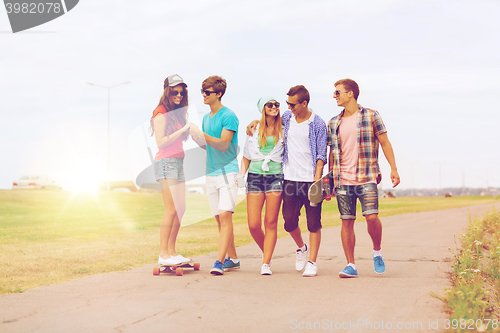 Image of group of smiling teenagers with skateboards