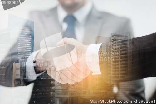 Image of two businessmen shaking hands in office