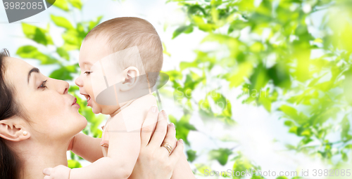 Image of happy mother kissing adorable baby