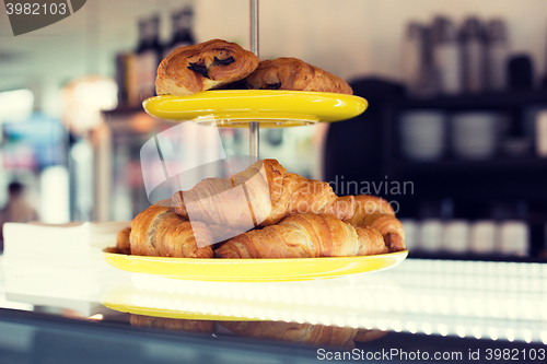 Image of close up of croissants and buns on cake stand