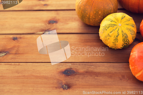 Image of close up of pumpkins on wooden table at home