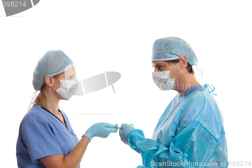 Image of Scrub nurse handing surgeon forceps