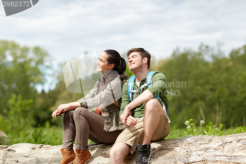 Image of smiling couple with backpacks in nature