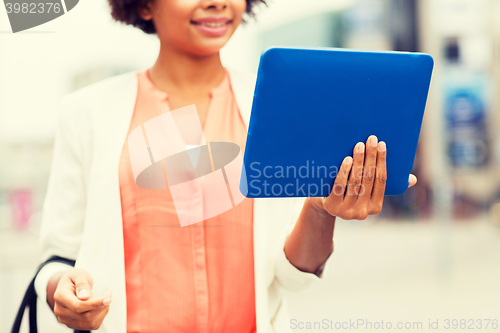 Image of close up of african woman with tablet pc in city