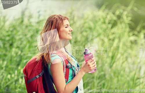Image of woman with backpack and bottle of water hiking