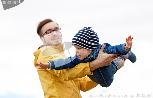 Image of father with son playing and having fun outdoors