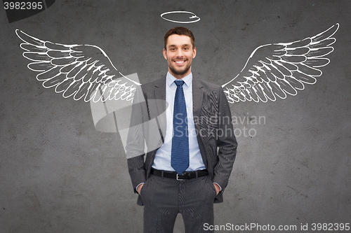 Image of smiling businessman with angel wings and nimbus